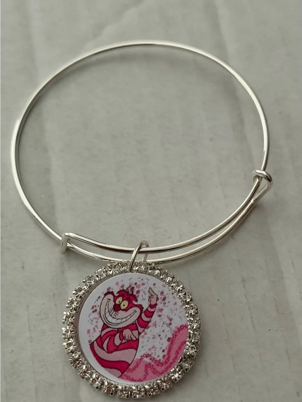 Silver-Tone Charm Bangle Bracelet with Pink Cheshire Cat Medallion